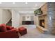 Basement living area with a stone fireplace, TV, recessed lighting, and staircase access at 8155 W Tennessee Dr, Lakewood, CO 80226