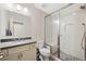 Modern bathroom with a glass-enclosed shower, sleek vanity, and contemporary fixtures at 8155 W Tennessee Dr, Lakewood, CO 80226