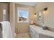Bright bathroom with a double sink vanity, modern fixtures, and an enclosed shower at 8155 W Tennessee Dr, Lakewood, CO 80226
