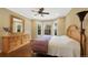 Bedroom featuring wood floors, large windows, and a dresser with a decorative mirror at 8155 W Tennessee Dr, Lakewood, CO 80226