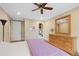Bedroom featuring wood floors, ceiling fan, dresser and en suite bathroom access at 8155 W Tennessee Dr, Lakewood, CO 80226