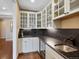 Butler pantry with wine fridge, granite counters, and custom cabinets at 8155 W Tennessee Dr, Lakewood, CO 80226
