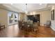 Elegant dining room features hardwood floors, modern chandelier, and glass doors at 8155 W Tennessee Dr, Lakewood, CO 80226