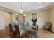 Bright dining room features a glass table and modern chandelier at 8155 W Tennessee Dr, Lakewood, CO 80226