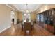 Open dining room with hardwood floors, statement chandelier, and ample space for entertaining at 8155 W Tennessee Dr, Lakewood, CO 80226