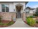 Inviting front entrance with stone accents, covered porch, and manicured landscaping at 8155 W Tennessee Dr, Lakewood, CO 80226