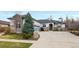 Charming home with stone accents, manicured lawn, and large driveway offers great curb appeal at 8155 W Tennessee Dr, Lakewood, CO 80226