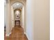 Hallway with arched doorway and wood floors at 8155 W Tennessee Dr, Lakewood, CO 80226