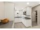 A stylish kitchen featuring white cabinetry, sleek countertops, stainless steel appliances, and modern lighting at 8155 W Tennessee Dr, Lakewood, CO 80226
