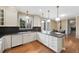 Updated kitchen with black countertops and white cabinets at 8155 W Tennessee Dr, Lakewood, CO 80226