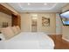 Bright main bedroom with a peek into the en suite bathroom, hardwood floors, and white trim at 8155 W Tennessee Dr, Lakewood, CO 80226