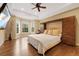 Spacious main bedroom with wood floors, a ceiling fan, built-in storage and large windows at 8155 W Tennessee Dr, Lakewood, CO 80226