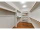 Walk-in closet with custom shelving and wood rods for ample storage at 8155 W Tennessee Dr, Lakewood, CO 80226