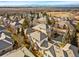 Beautiful aerial view of a neighborhood with scenic landscape and distant mountain views at 13990 E Chenango Dr, Aurora, CO 80015