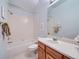 Bright bathroom featuring a tub-shower combination with a white tile surround at 13990 E Chenango Dr, Aurora, CO 80015