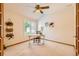 Cozy bedroom featuring a ceiling fan, natural light, and decorative wall art at 13990 E Chenango Dr, Aurora, CO 80015
