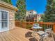 Spacious outdoor deck with wood railing and seating area at 13990 E Chenango Dr, Aurora, CO 80015