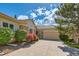 Charming single-story home with a well-maintained lawn and a two-car garage at 13990 E Chenango Dr, Aurora, CO 80015