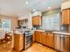 Well-equipped kitchen with stainless steel appliances, wooden cabinets, and granite countertops at 13990 E Chenango Dr, Aurora, CO 80015
