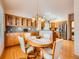 Eat-in kitchen with hardwood floors, stainless appliances, and ample cabinet space at 13990 E Chenango Dr, Aurora, CO 80015