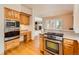 Open kitchen with island and stainless steel appliances at 13990 E Chenango Dr, Aurora, CO 80015
