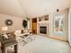 Comfortable living room featuring a fireplace and large window at 13990 E Chenango Dr, Aurora, CO 80015