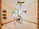 Well lit office space with white walls, ceiling fan, and light neutral carpet at 13990 E Chenango Dr, Aurora, CO 80015