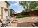 Private backyard with a fire pit, gravel, seating, and fenced perimeter at 3940 Malaya St, Denver, CO 80249