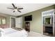 Bedroom with view to ensuite bathroom, large windows and ceiling fan at 3940 Malaya St, Denver, CO 80249