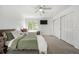 Large bedroom with two twin beds, neutral carpet, ceiling fan, and bright natural light at 3940 Malaya St, Denver, CO 80249
