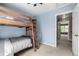 Cozy bedroom with bunk beds, neutral carpet, and view of hallway beyond the door at 3940 Malaya St, Denver, CO 80249