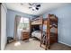 Cozy bedroom with bunk beds, a window that provides natural light, and wood furnishings at 3940 Malaya St, Denver, CO 80249