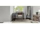Desk and chair positioned near a large window in a bedroom with neutral colored walls and carpet at 3940 Malaya St, Denver, CO 80249