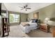 Bedroom features a large window providing natural light, and a ceiling fan at 3940 Malaya St, Denver, CO 80249