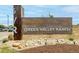 Community entrance sign for Green Valley Ranch Golf Course, with stone accents and manicured landscaping at 3940 Malaya St, Denver, CO 80249