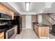Well lit kitchen features tile floors, stainless steel appliances and plenty of cabinet space at 3940 Malaya St, Denver, CO 80249