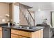 Eat-in kitchen features double sinks, stairs to the upper level and an eat-in bar at 3940 Malaya St, Denver, CO 80249