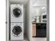 A compact laundry area provides a stacked washer and dryer at 3940 Malaya St, Denver, CO 80249