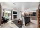 Open-concept living room boasts a fireplace, large windows, and seamless flow to the kitchen for modern living at 3940 Malaya St, Denver, CO 80249