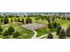 Aerial view of community tennis courts surrounded by green spaces, pathways, and residential area at 3940 Malaya St, Denver, CO 80249