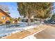 Exterior street view of condo complex with snow covered grass and trees at 3576 S Depew St # 302, Lakewood, CO 80235