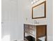 Bathroom vanity with modern sink, wood cabinets, and bright lighting at 11912 Madison Pl, Thornton, CO 80223