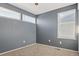 Bedroom featuring two windows, carpeted floor, and a ceiling fan at 11912 Madison Pl, Thornton, CO 80223
