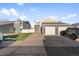 Inviting two-story townhouse features a two-car garage, manicured lawn, and ample driveway at 11912 Madison Pl, Thornton, CO 80223