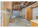 Spacious garage providing ample parking and storage space, with unfinished walls and exposed ceiling at 11912 Madison Pl, Thornton, CO 80223