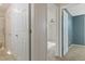 Hallway with doors leading to various rooms, including a bathroom and bedroom at 11912 Madison Pl, Thornton, CO 80223