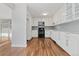 Bright eat-in kitchen features white cabinets, granite countertops, and stainless steel appliances at 11912 Madison Pl, Thornton, CO 80223
