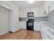 Eat-in kitchen features white cabinets, granite countertops, and stainless steel appliances at 11912 Madison Pl, Thornton, CO 80223