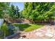 Backyard with wooden fence, lush trees, and stone pathway at 18672 E Chaffee Pl, Denver, CO 80249
