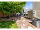 Backyard features a stone pathway and mature trees at 18672 E Chaffee Pl, Denver, CO 80249